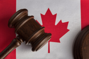 Judge gavel on Canada flag close up. Canadian legislation concept