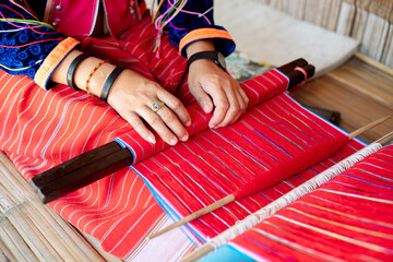 Pattaya, THAILAND - September 17, 2018: woman in thai ethnic dress doing handiwork in Padaung Tribe Village of Long Neck People