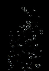 Bubble soda and white oxygen air, in underwater clear liquid with bubbles flowing up on the water surface, On a black background