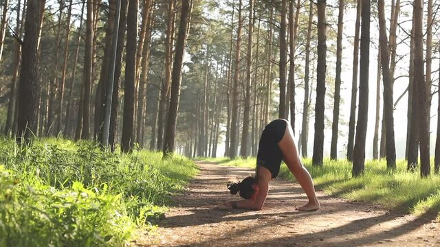 Young girl doing yoga fitness exercise outdoor. Morning sunrise. Meditation and relax