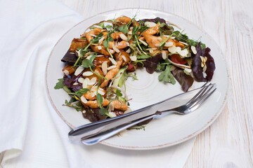 Exotic salad on a large dish in the restaurant, beautifully served salad with chicken