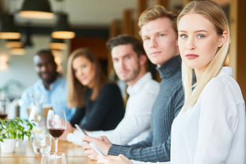 Young people in the restaurant with mobile phone addiction