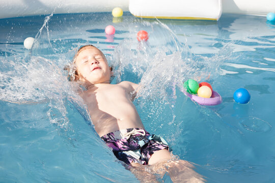 boy jump in pool stock photo