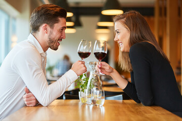 Couple in love drinking wine in the restaurant