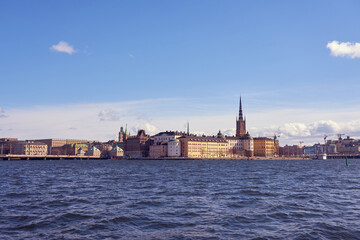 Fototapeta na wymiar Old city of Stockholm under the blue cloudy sky.