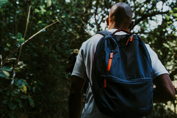Rear view of young man with backpack on a hike in Pugu hills in Kisarawe Tanzania