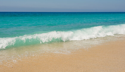 Fototapeta na wymiar blue sea, white wave and clean sand on the cleopatra beach in alanya 