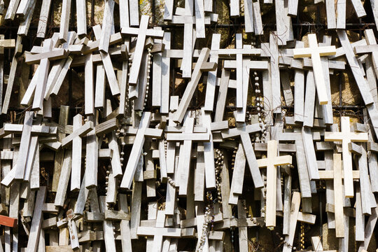 Wooden cross symbol of christianity texture. Holy wall catholic religion. Hanging rosary background. Pilgrimage destination in Poland. Święta woda near Białystok city in Podlasie region. © Paweł Michałowski