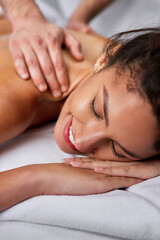 Fototapeta na wymiar Close-up of beautiful woman having back massage at health spa.