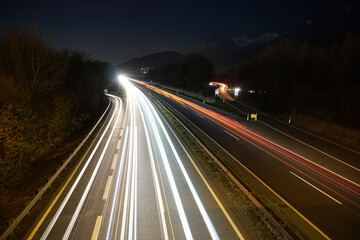 Fototapeta na wymiar Night car light trails long exposure shot with mountain range scenerie