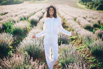 Young smiling woman in white dress in field 