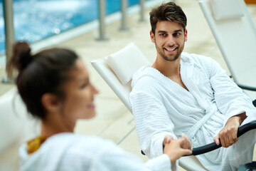 Fototapeta premium Happy man and his girlfriend holding hands while relaxing at health spa.