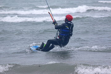 kitesurfer riding his board
