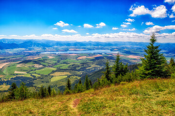 Obraz premium Landscape view on region Liptov and lake Liptovska Mara from hill Babky in Western Tatras