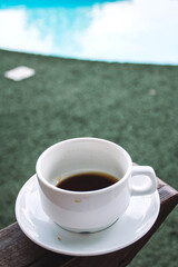 cup of coffee on the background of the pool