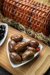 different types of olives on a dark concrete