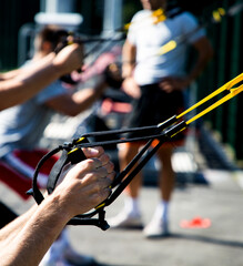 trx training outdoors focus on strong male hands