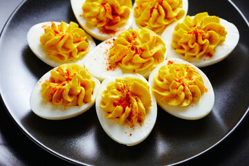 Easter party snack deviled eggs on a black plate