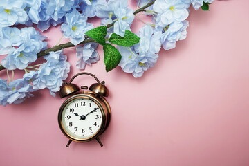 Vintage Alarm Clock And Tulip Bouquet with space copy on pink background