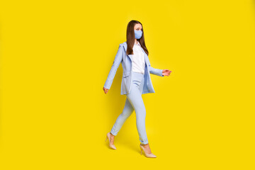 Fototapeta na wymiar Full length photo serious chief investor go walk copyspace office safe medical mask covid infection wear blue blazer jacket trousers pants high-heels isolated bright shine color background