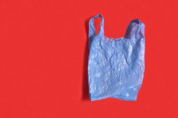 blue plastic bag on red background