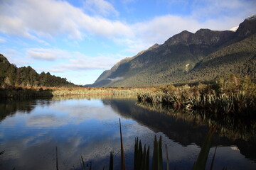 View of Mirror lakes and crystal-clear reflections on a still day during Winter in Fiordland National park New Zealand