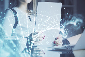 DNA theme hologram over woman's hands writing background. Concept of education. Double exposure