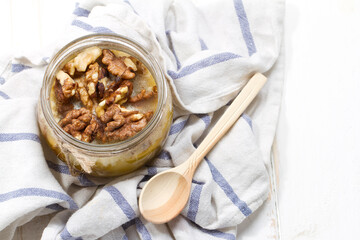 Altai candied honey with walnuts in a glass jar