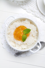 Rice porridge with orange marmalade and lemon balm leaves
