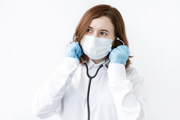 Portrait of a doctor in uniform holding a stethoscope in his hand on a white background. Healthcare workers in the Coronavirus Covid19 pandemic