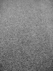 Black and white close up shot of a road   