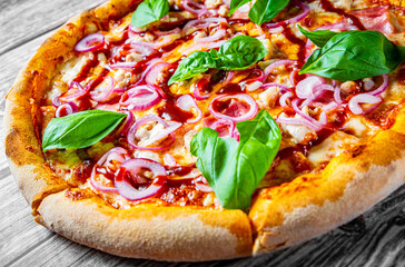 Pizza with chicken and barbeque sauce . Italian pizza on wooden table background