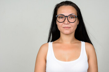 Portrait of beautiful woman with eyeglasses against white background