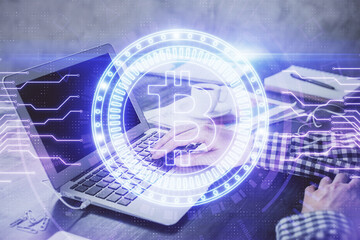 Blockchain theme hologram with man working on computer on background. Concept of crypto chain. Double exposure.