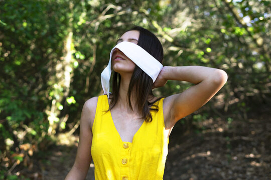 Woman Taking Off Blindfold In Forest. Environment Concept.