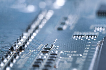 Chip in beautiful blue lighting. Industrial production of circuit boards.