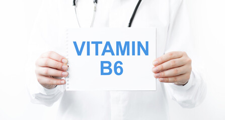 The female doctor, with the plate Vitamin B6, medical concept