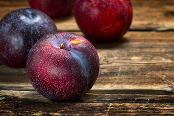Red plums in rustic style