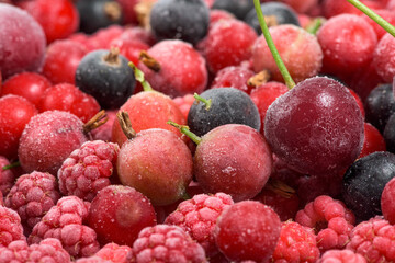 frozen fruit cherry, raspberry, blackcurrant in bags, close-up view from above