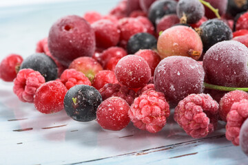 frozen fruit cherry, raspberry, blackcurrant in bags, close-up view from above