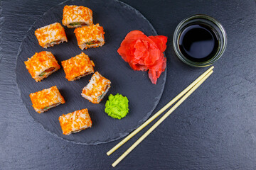 Sushi rolls Philadelphia on a black slate. Top view