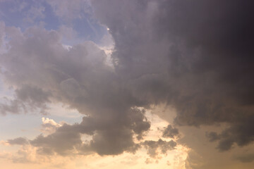 Aerial sunset or sunrise sky over a lake framed with scattered clouds varying in color.