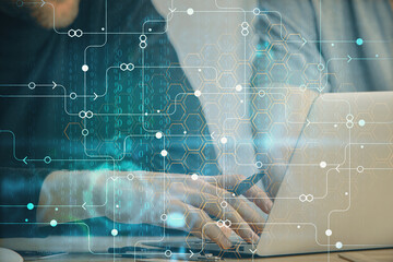 Multi exposure of data internet theme hologram with man working on computer on background. Concept of innovation.