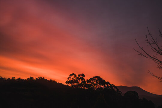 sunset sky with beautiful clouds rolling over the hills of Tasmania, Australia