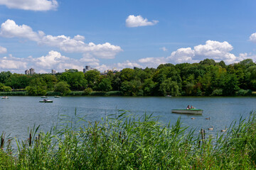 tourists enjoy a boat ride on the Max-Eyth Lake in Stuttgart in summer