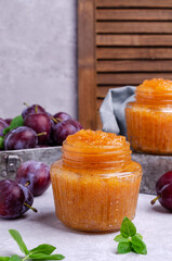 Yellow plum jam in a glass jar
