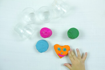 colored mass for modeling, decorative dough for children's creativity, baby made a heart