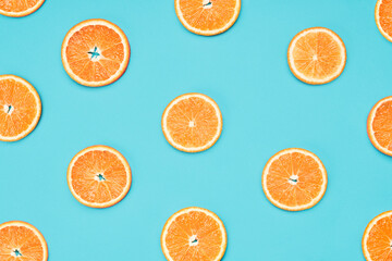 Orange slices on blue background. Food wallpaper