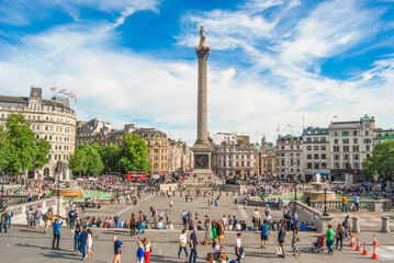 Trafalgar Square with Nelson Pillar and a crowd of people walking around, London, June 2019. - obrazy, fototapety, plakaty