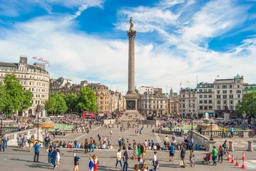 Fototapeten Trafalgar Square with Nelson Pillar and a crowd of people walking around, London, June 2019. © AlexMastro